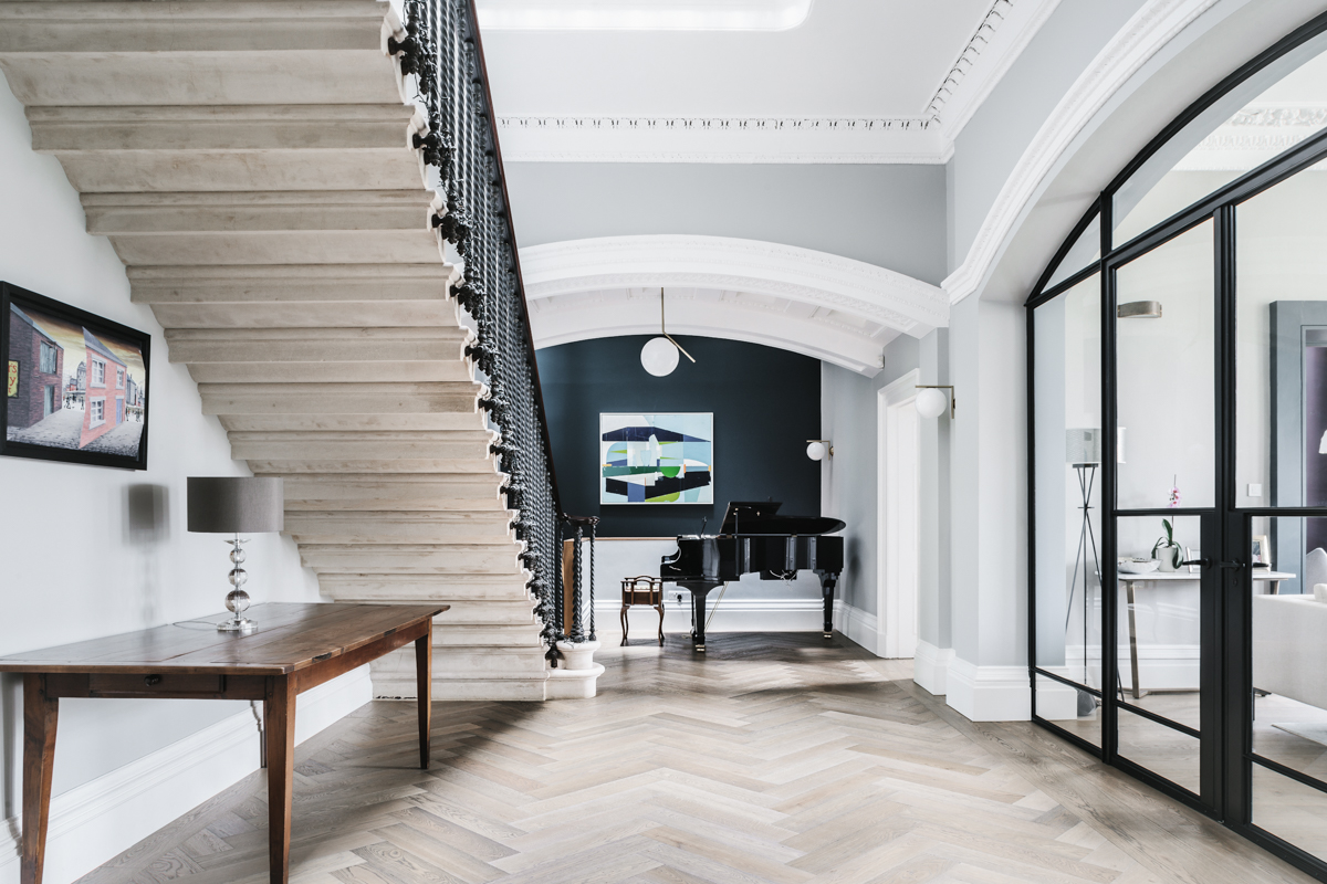 Hallway with original staircase and a piano at Clifton Villa in Bristol